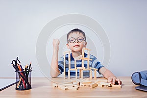 Asian boy playing with a wooden puzzle