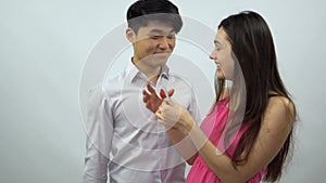 Asian boy presents Valentine card to girl on a white background