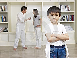 Asian boy and quarreling parents photo