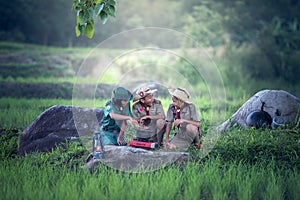 Asian Boy-scout staged a halt with a campfire