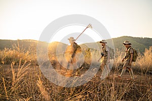 Asian Boy Scout students wearing scout uniforms and backpacks trekking in a mountain camp. The concept of long distance travel