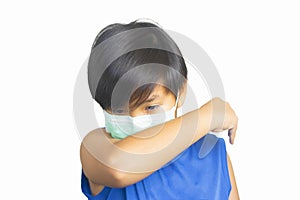 Asian boy sickness in medical mask,coughs his elbow and sneeze into arm,isolated white background,concept pandemic epidemic