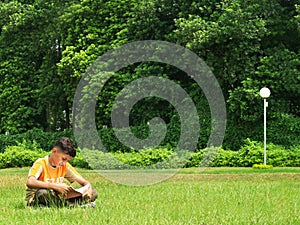 Asian boy studying outdoors