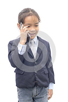 Asian boy in suit talking on mobile phone over white