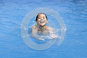 Asian boy is swimming in pool