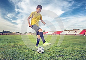 Asian boy teenager playing football at the stadium, sports, outdoor activities
