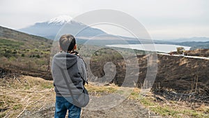 Asian boy on top of Yamanakako Panoramadai look mt. Fuji view