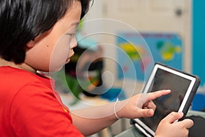 Asian boy use tablet online learn from home