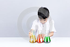 Asian boy is viewing test color combination on science experiment education