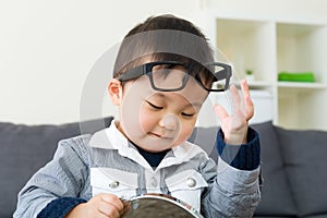 Asian boy wear glasses with mirror