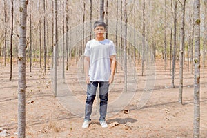 Asian boy in white casual and jeans trousers are standing in the