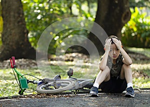 Asian boy worried after a bicycle accident