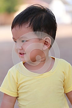 Asian boy in yellow dress and he smiled are happy.