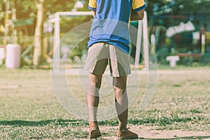 Asian boys practice kicking the ball to score goals