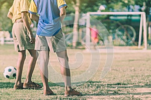 Asian boys practice kicking the ball to score goals