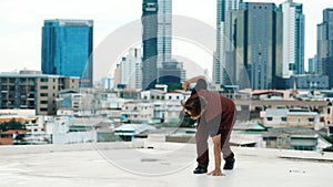 Asian break dancer practice B boy dance with friends at roof top. Endeavor.