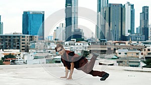 Asian break dancer practice B boy dance with friends at roof top. Endeavor.