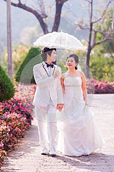 Asian Bride and Groom on Natural Background