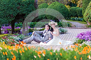 Asian Bride and Groom Sitting Together in Garden