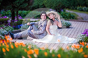 Asian Bride and Groom Sitting Together in Garden