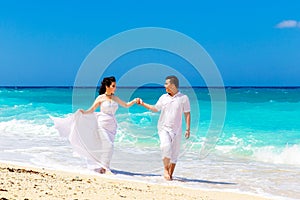 Asian bride and groom on a tropical beach. Wedding and honeymoo
