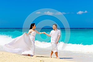 Asian bride and groom on a tropical beach. Wedding and honeymoon