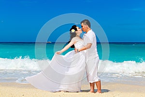 Asian bride and groom on a tropical beach. Wedding and honeymoon