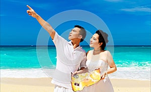 Asian bride and groom on a tropical beach. Wedding and honeymoon