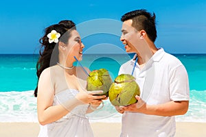 Asian bride and groom on a tropical beach. Wedding and honeymoon