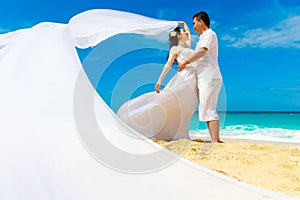 Asian bride and groom on a tropical beach. Wedding and honeymoon