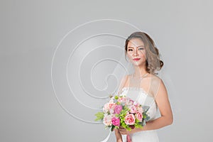 Asian bride standing and holding a bouquet