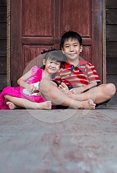 Asian brother with his sister smiling happy together.