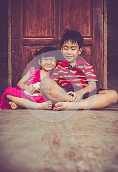 Asian brother with his sister smiling happy together. Vintage t