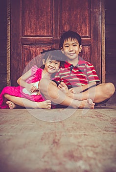 Asian brother with his sister smiling happy together. Vintage t