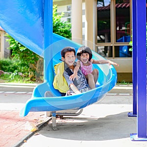 Asian brother and sister enjoy playground