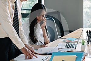 Asian business adviser meeting to analyze and discuss the situation with laptop computer in the meeting room. Investment