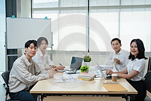 Asian business advisor meeting to analyze and discuss the situation on the financial report in the meeting room