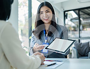 Asian business customer service representatives work and smile serve sell credit card to customers. choosing insurance plan in