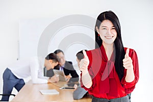 Asian business girl ceo show two hand thumb up good working together