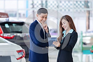 Asian business man bargain purchasing brand new car, Car rental business in auto showroom
