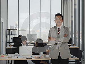 Asian business man cross arms with confident in office