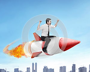 Asian business man flying ride rocket