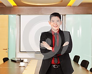 Asian business man with folded hand smiling