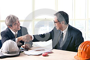 asian business man shaking hand in office meeting room successful project solution theme