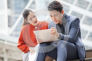 asian business man upset of bad news or problems in laptop business woman or colleague consoling . manager and secretary . stress