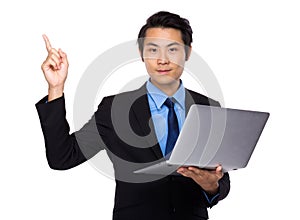 Asian Business man use of laptop and finger point up