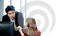 Asian business man and woman call center talk about support service in workspace with white copy space background