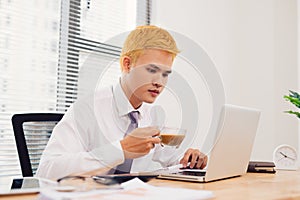 Asian Business man working at office with laptop and documents,Financial document graph on his desk, consultant lawyer concept