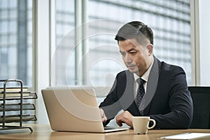 asian business man working in office using laptop computer