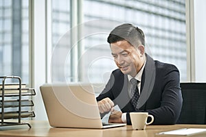 asian business man working in office using laptop computer